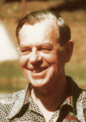 Joseph Campbell in the late 1970s, laughing, outdoors in a patterned short-sleeved shirt.